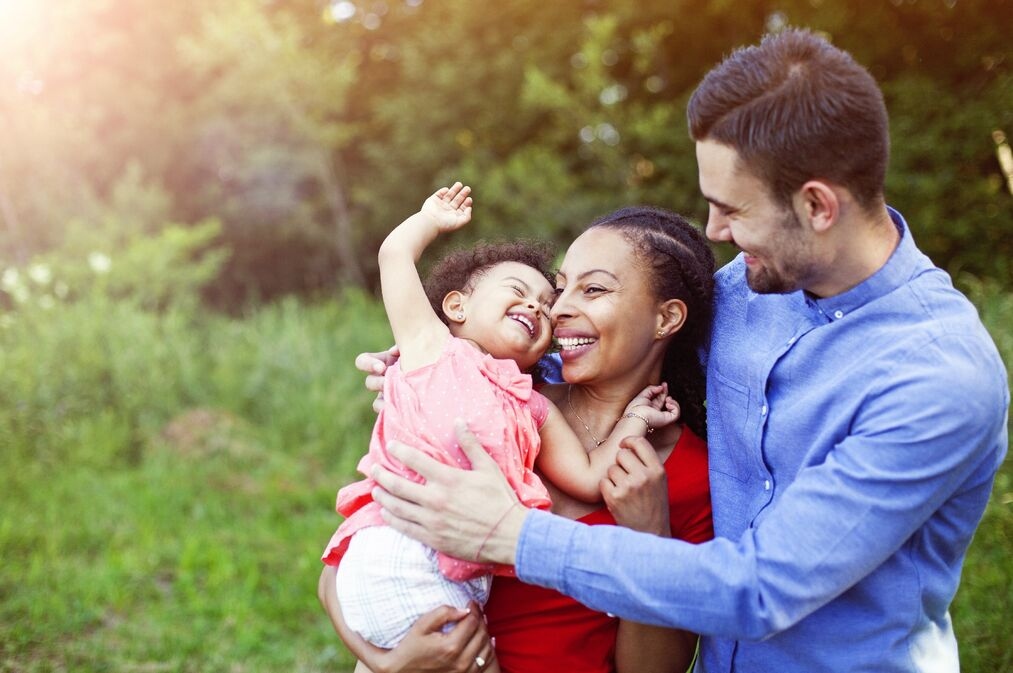 Family outdoors smiling