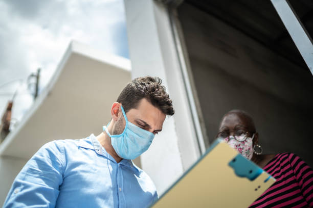 Two people in masks going through checklist