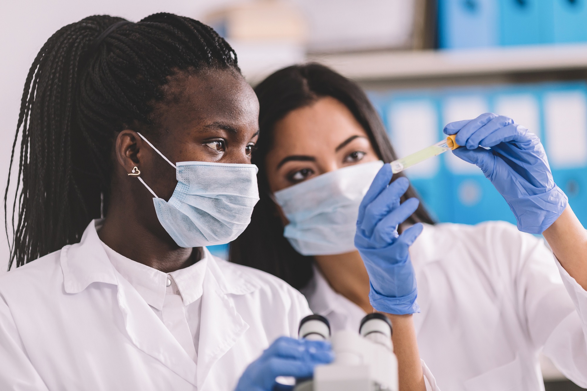 Three clinical employees discuss work during a break